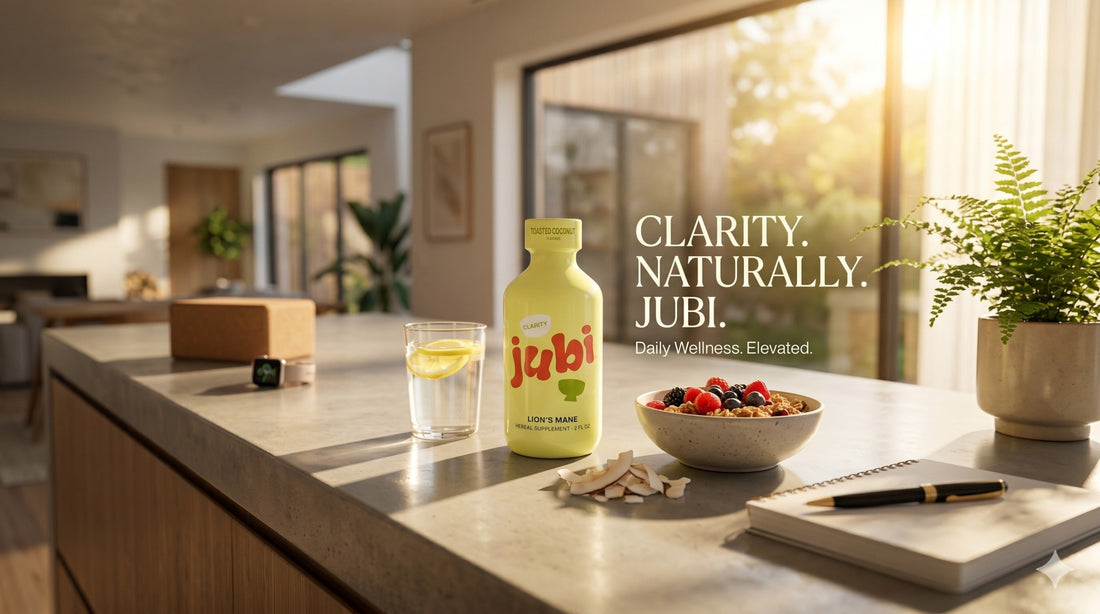 Premium wellness advertisement for Jubi Lion's Mane herbal supplement, showing the pale yellow bottle on a sunlit kitchen counter next to a glass of lemon water, a fresh berry granola bowl, a notebook, and a yoga block under warm morning sunlight.