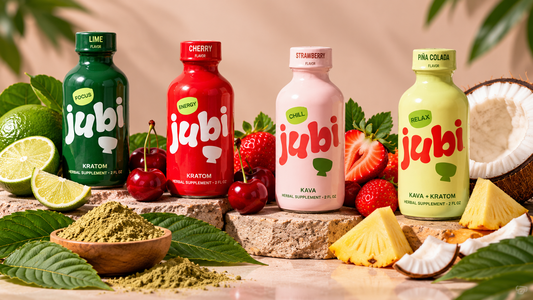 Jubi kratom shots in lime, cherry, strawberry, and piña colada flavors with kratom leaves, powder, and fresh fruit.